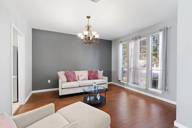 a living room with furniture and a chandelier