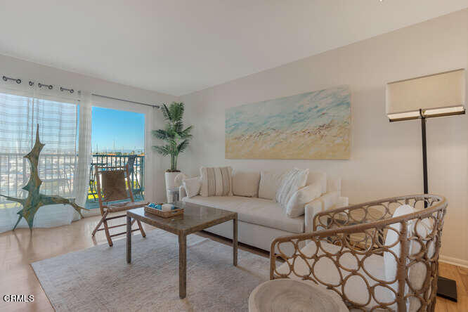 3101 Peninsula Road, Unit 208 Oxnard, CA 93035 - Photo 4 of 30 a living room with furniture and a potted plant