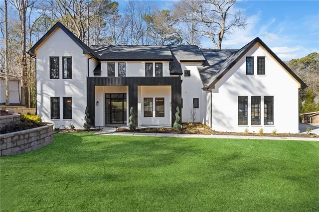 a front view of a house with a garden