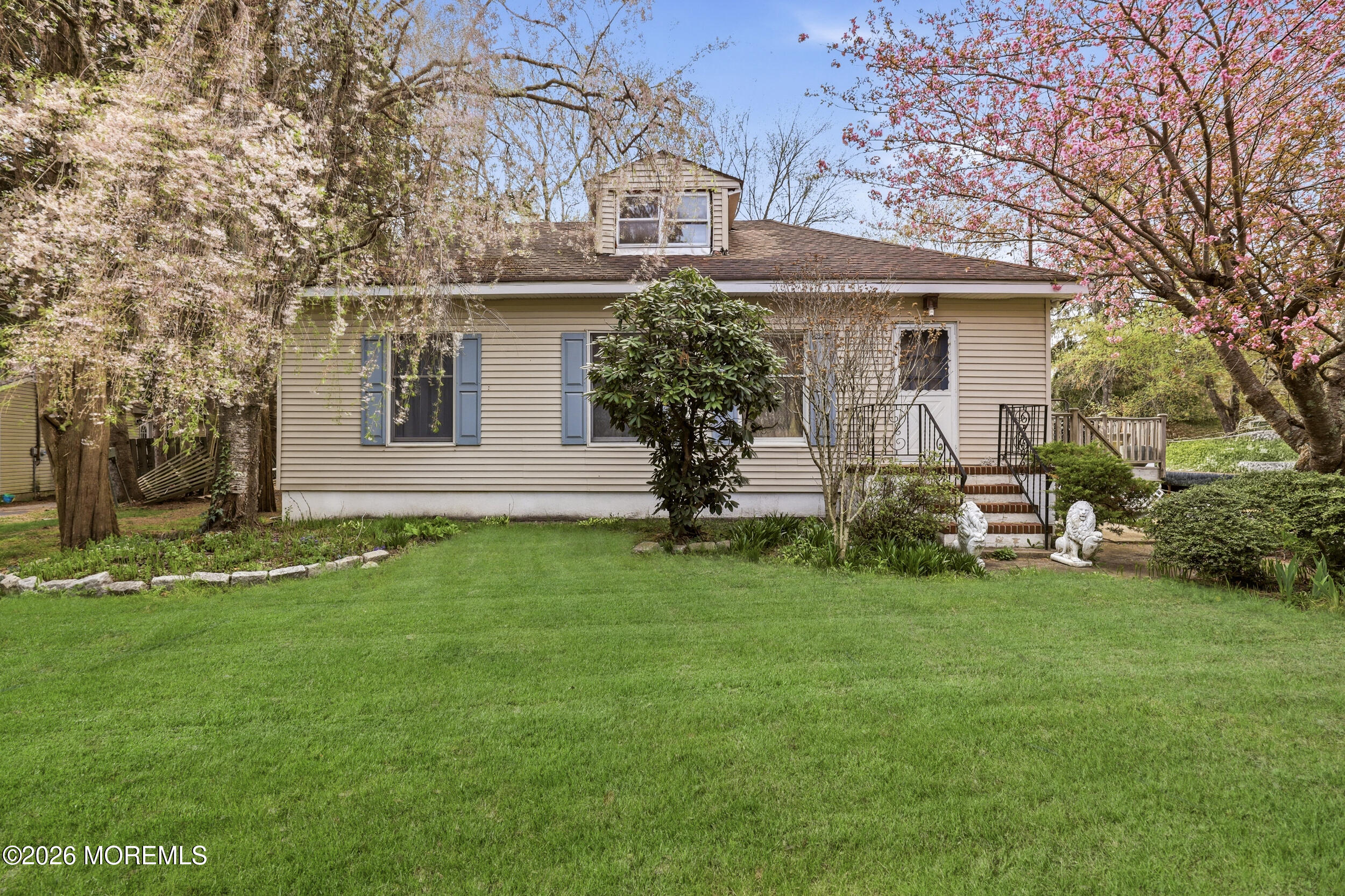 a front view of a house with a garden