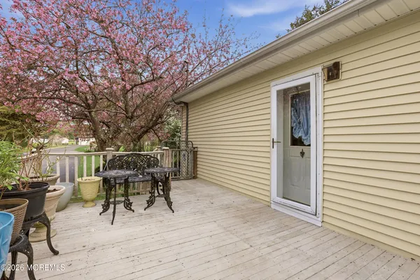 a view of a house with a backyard and trees