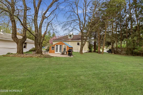 a view of a backyard with large trees