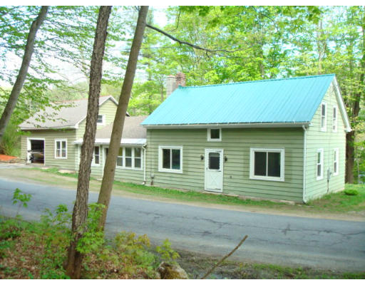 185 Call Road Colrain, MA 01340 - Photo 1 of 12 a front view of a house with garden