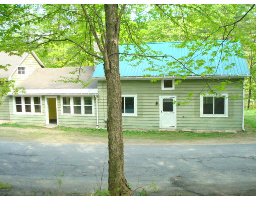 185 Call Road Colrain, MA 01340 - Photo 9 of 12 a view of a yard in front of a house with a large tree