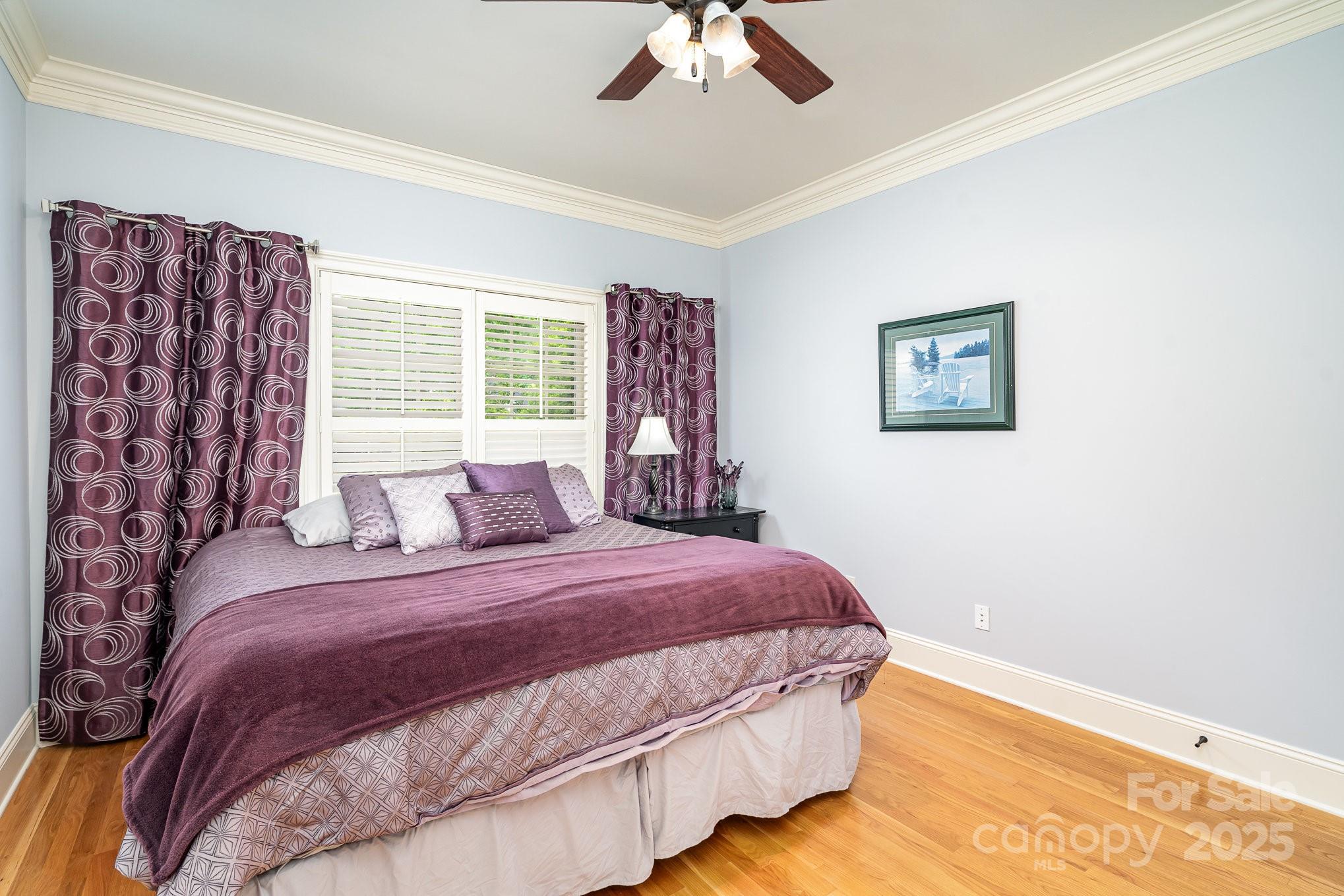 112 Spring Branch Road Fort Mill, SC 29715 - Photo 27 of 43 a bedroom with a large bed and a chandelier