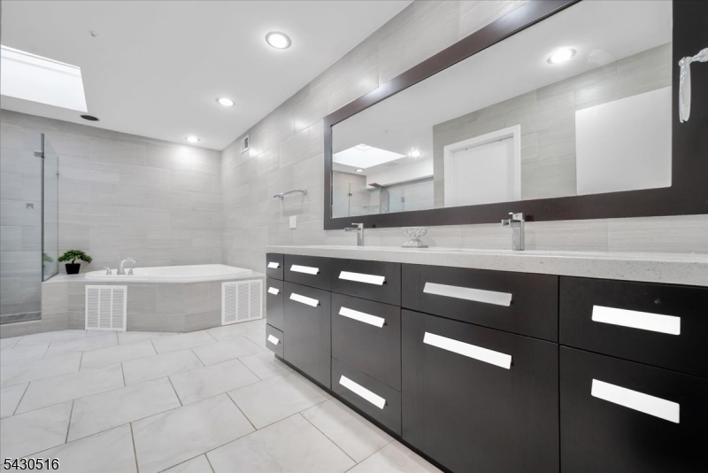 950 Sunset Ridge Bridgewater, NJ 08807 - Photo 31 of 41 a bathroom with a granite countertop bathtub sink vanity and mirror