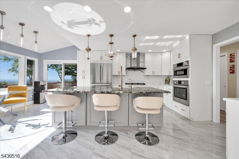 950 Sunset Ridge Bridgewater, NJ 08807 - Photo 10 of 41 a room with stainless steel appliances a dining table and chairs