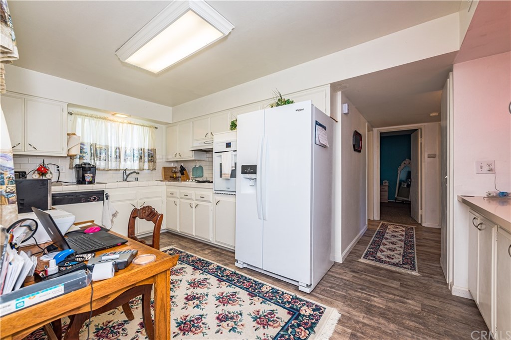 28241 Winged Foot Drive Menifee, CA 92586 - Photo 13 of 25 a kitchen with stainless steel appliances granite countertop a refrigerator and a stove top oven