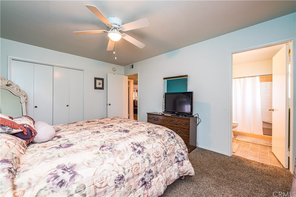 28241 Winged Foot Drive Menifee, CA 92586 - Photo 18 of 25 a bedroom with a bed and a flat screen tv