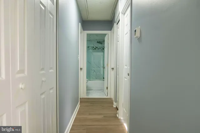 a view of a hallway with a wooden floor