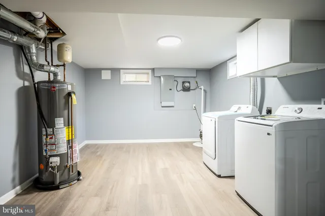 a view of a kitchen with refrigerator and wooden floor