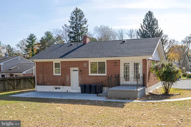 a view of a house with a yard and sitting area