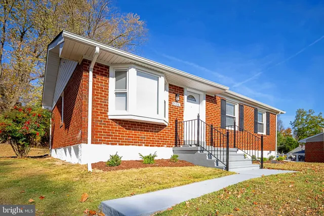 a backyard of a house with yard and outdoor seating