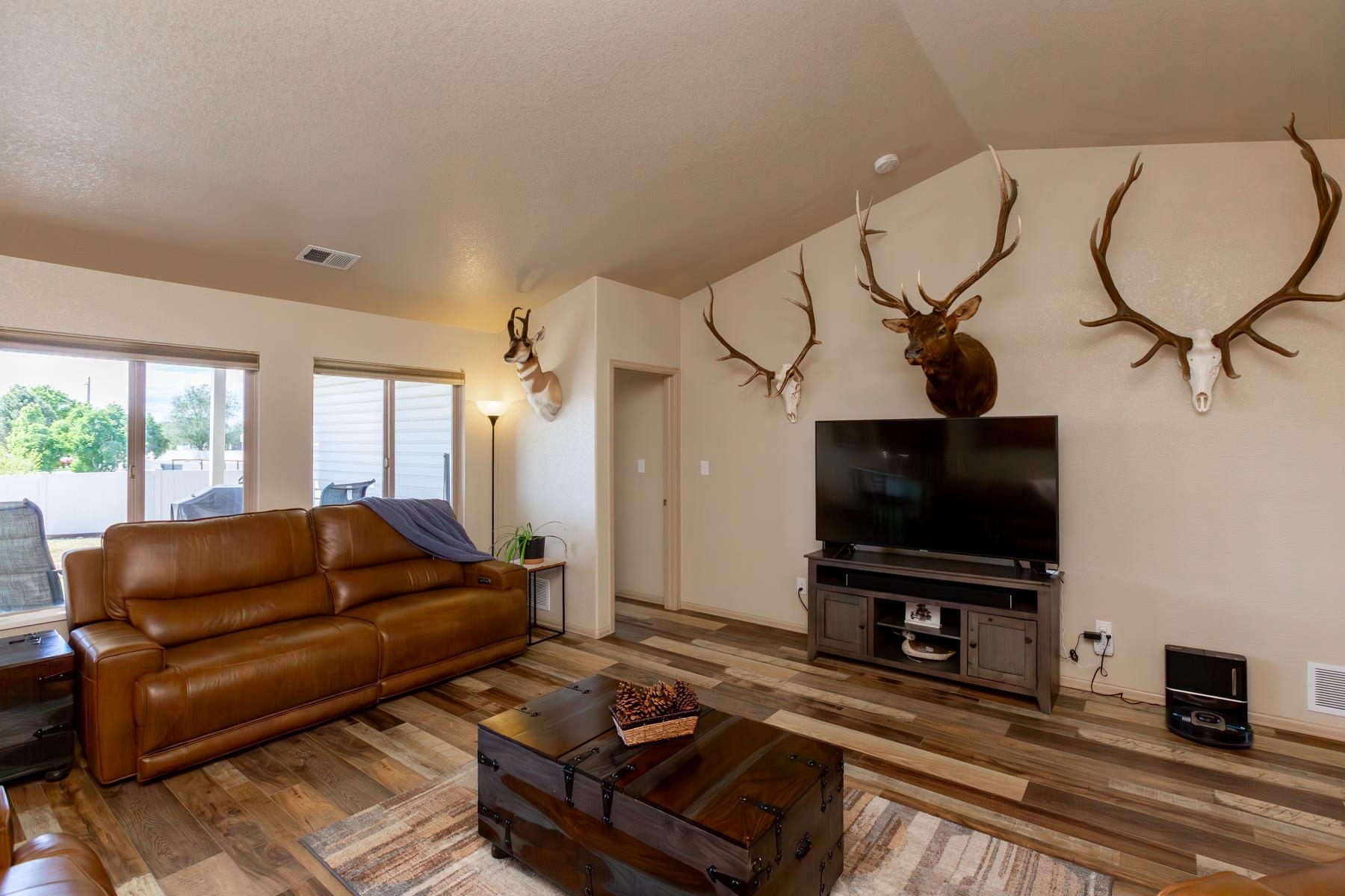 103 Red Rocks Street Fruita, CO 81521 - Photo 20 of 39 a living room with furniture and a flat screen tv