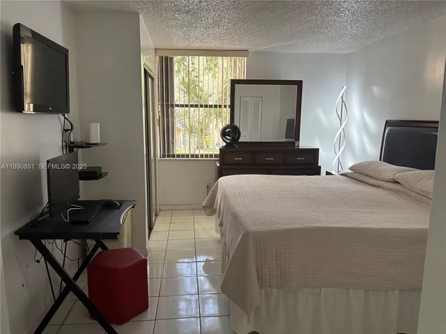 a bedroom with a bed and flat screen tv