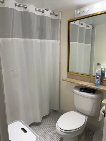 a white toilet sitting next to a bathroom sink
