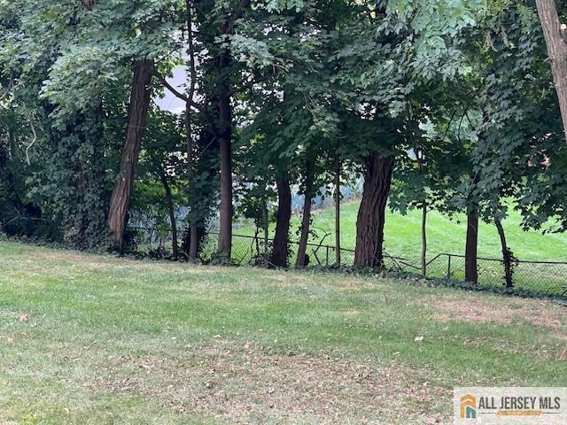 139 Rues Lane East Brunswick, NJ 08816 - Photo 17 of 17 a grassy field with trees in the background