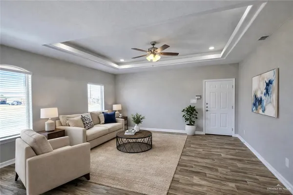 a living room with furniture and a chandelier