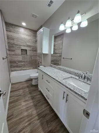 a bathroom with a double vanity sink and a mirror