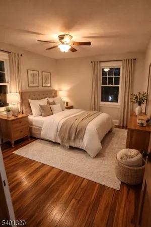 a spacious bedroom with a bed and wooden floor