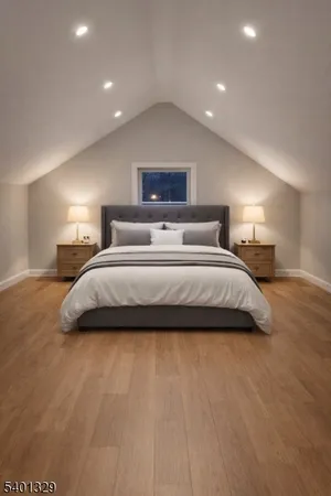 a spacious bedroom with a bed and a night stand