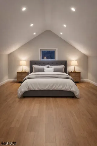 a spacious bedroom with a bed and a night stand