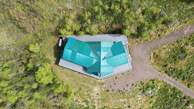 6 Beaver Springs Rancheros Oakley, UT 84055 - Photo 60 of 68 Hexagonal structure featuring a green metal roof and an expansive surrounding deck
