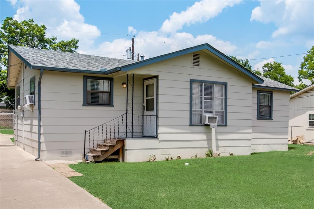 2426 May Lane Grand Prairie, TX 75050 - Photo 1 of 1 a front view of a house with a garden