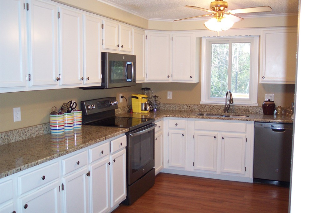 235 Turkey Hill Road Rutland, MA 01543 - Photo 4 of 9 a kitchen with granite countertop white cabinets white appliances a sink and a window