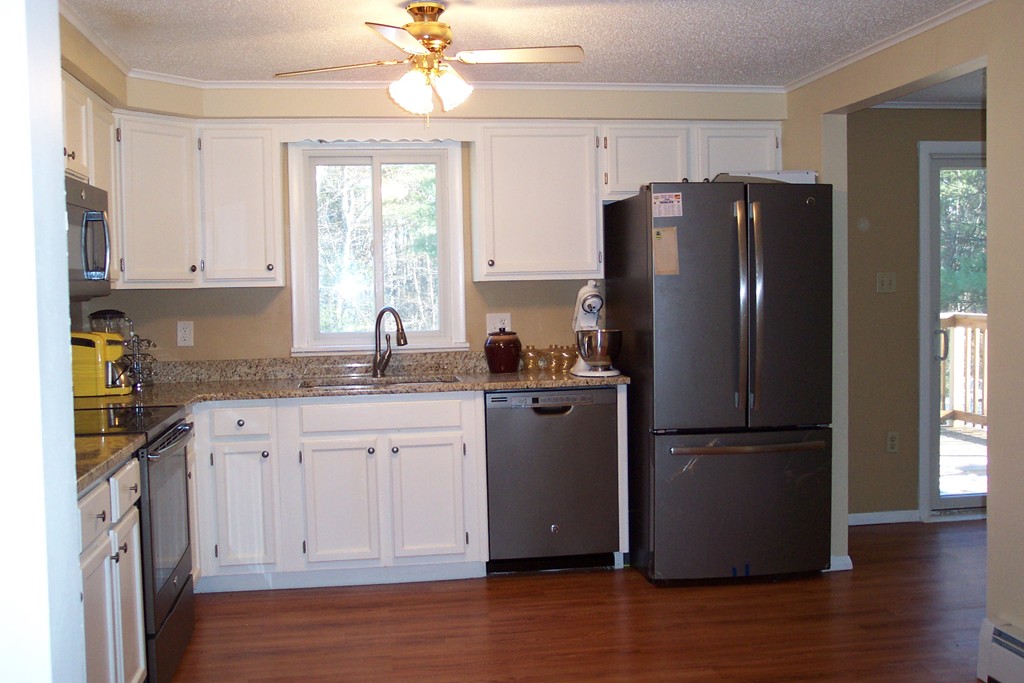 235 Turkey Hill Road Rutland, MA 01543 - Photo 5 of 9 a kitchen with granite countertop stainless steel appliances a refrigerator cabinets and wooden floor