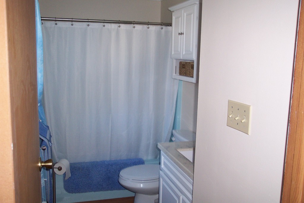 235 Turkey Hill Road Rutland, MA 01543 - Photo 7 of 9 a bathroom with a toilet and a shower curtain