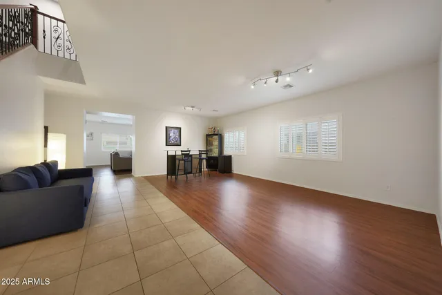 a living room with furniture and stairs