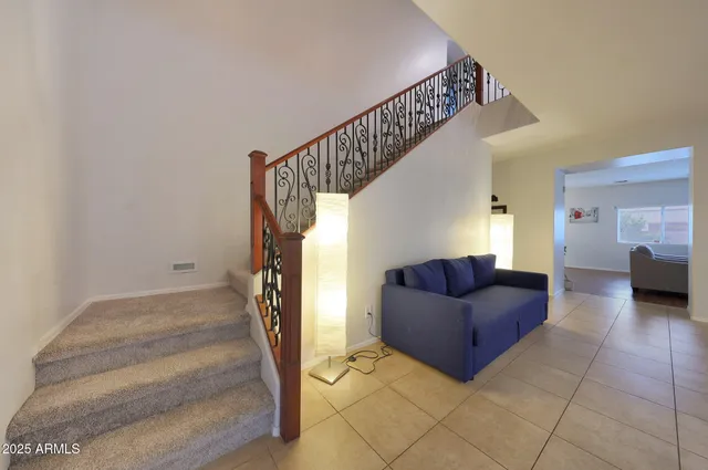 a living room with furniture and view of kitchen