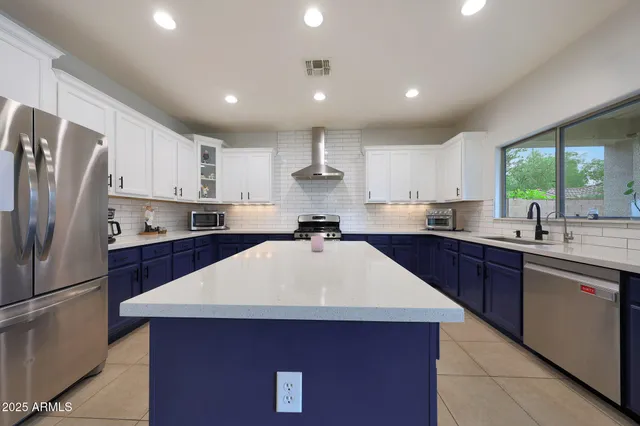 a kitchen with a sink cabinets and a window