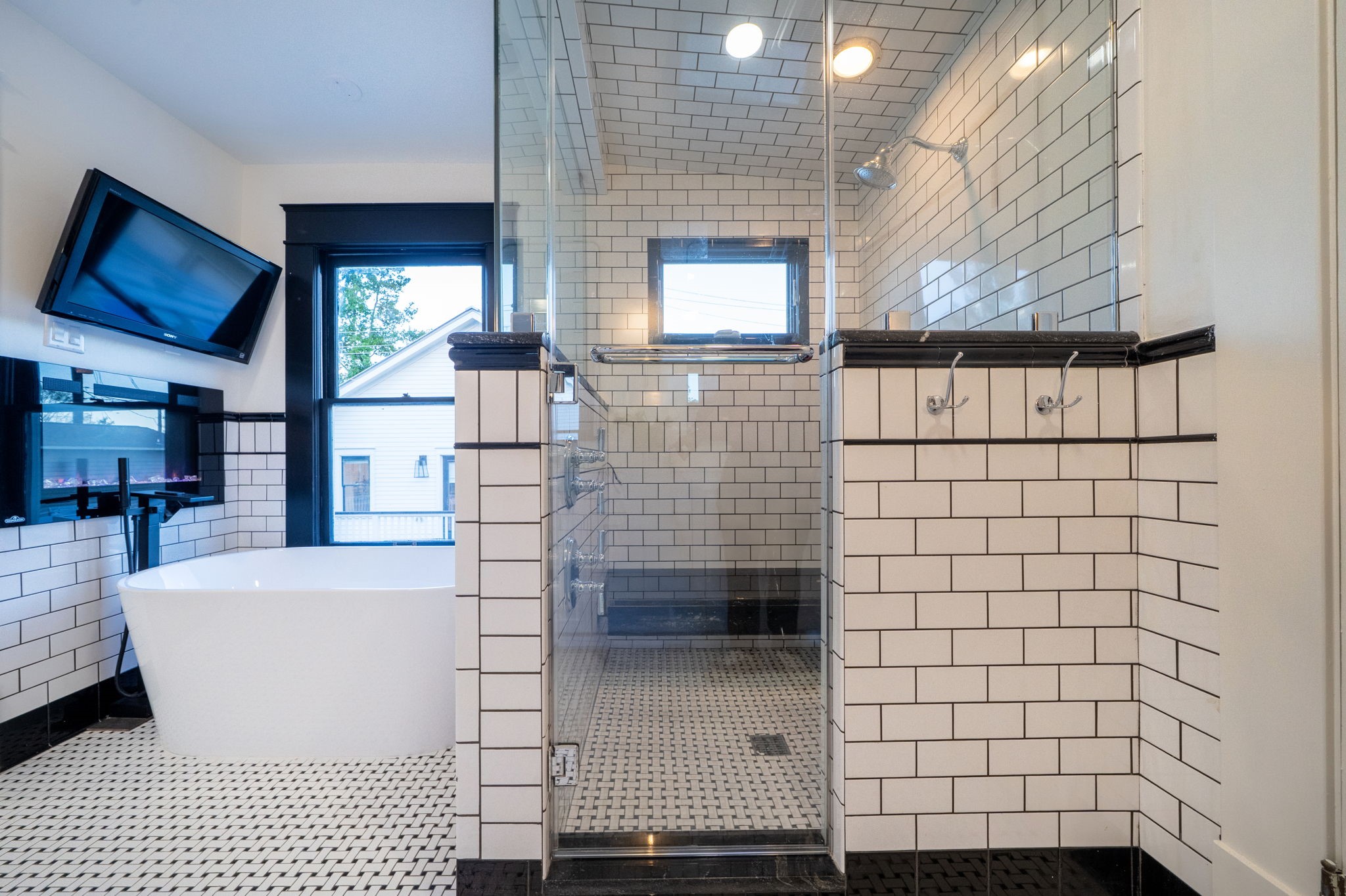 1109 Rutland Street Houston, TX 77008 - Photo 19 of 34 Step into pure luxury with this spa-like shower, where every detail is designed to impress. The fully tiled walls create a sleek, seamless look, while the extended bench invites you to relax and unwind in ultimate comfort. It's not just a shower—it's your own private retreat.