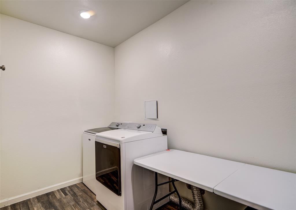 905 Avagail Avenue Springtown, TX 76082 - Photo 17 of 26 Laundry area featuring dark wood-style floors and separate washer and dryer