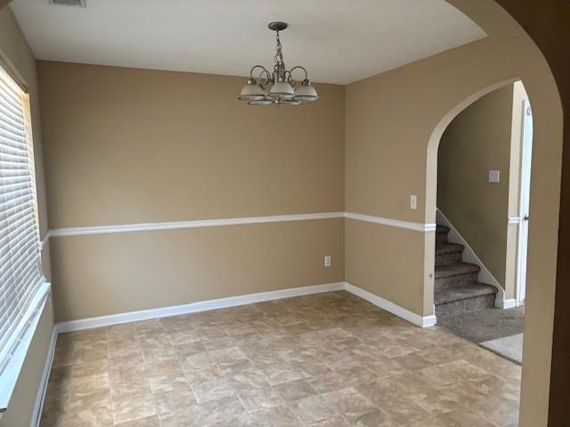 136 St Ann Circle Dallas, GA 30157 - Photo 12 of 44 an empty room with chandelier fan and windows