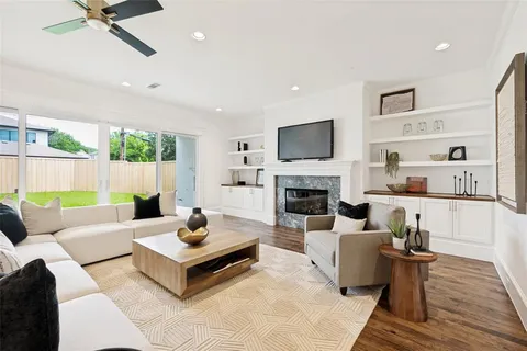 a living room with furniture fireplace and a flat screen tv