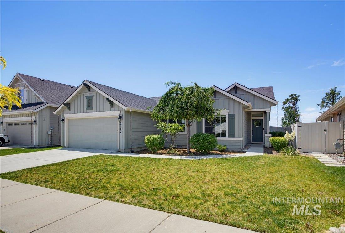 5317 West Lockner Street Eagle, ID 83616 - Photo 1 of 34 Contemporary single-story residence featuring light gray siding and a dark shingle roof