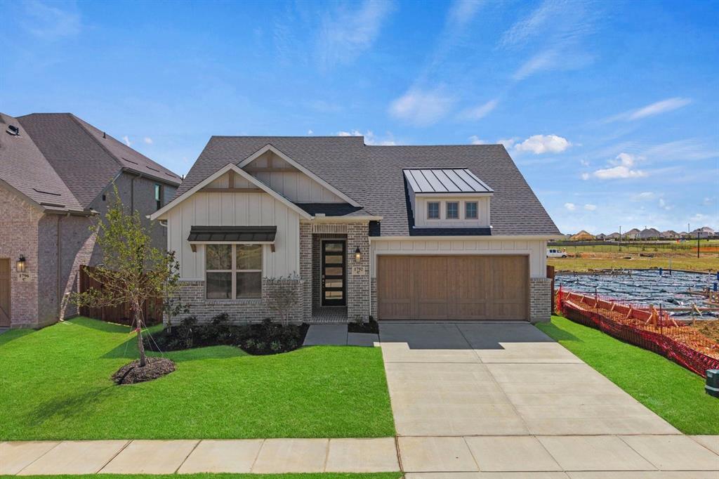 1792 Monarch Way Oak Point, TX 75068 - Photo 3 of 26 a front view of a house with garden