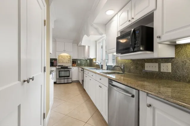a kitchen with a sink cabinets and window