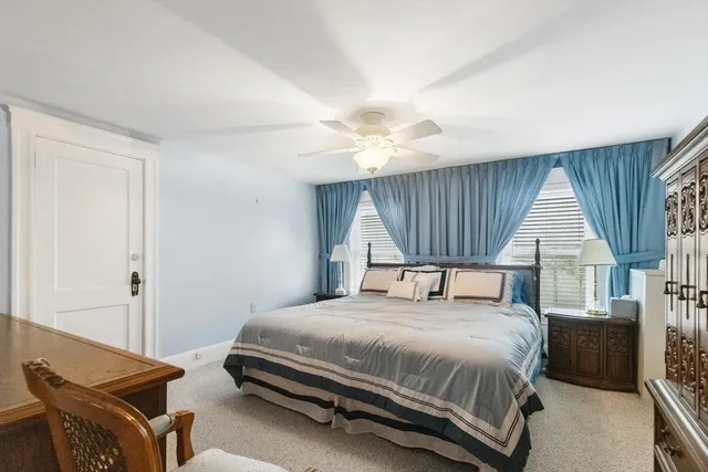 a bedroom with a bed a window and a dresser