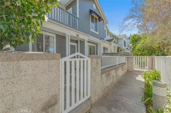a view of a house with wooden floor and a fence