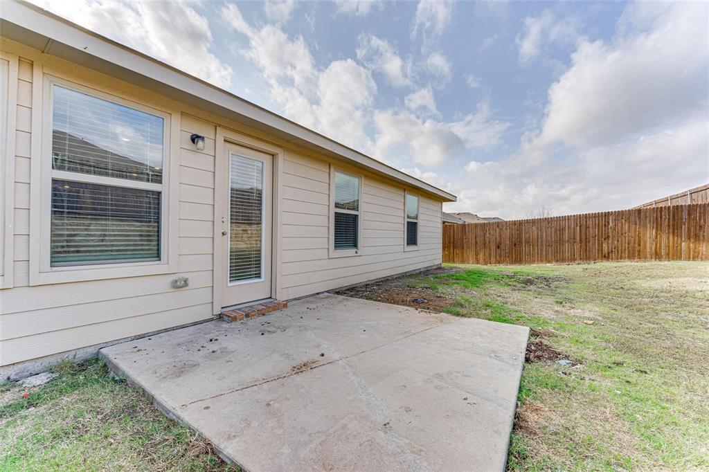 517 Milo Way Royse City, TX 75189 - Photo 25 of 34 Expansive backyard featuring a concrete patio, wood privacy fence, and beige exterior siding