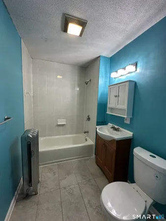 a bathroom with a sink a toilet and bathtub