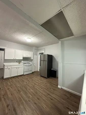 a kitchen with stainless steel appliances a refrigerator and a stove top oven