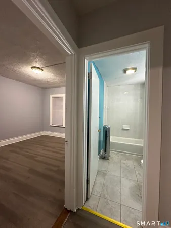 a view of a hallway with wooden shelves