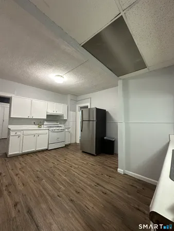 a view of a kitchen with wooden floor