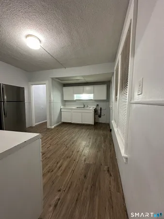 a view of hallway with wooden floor