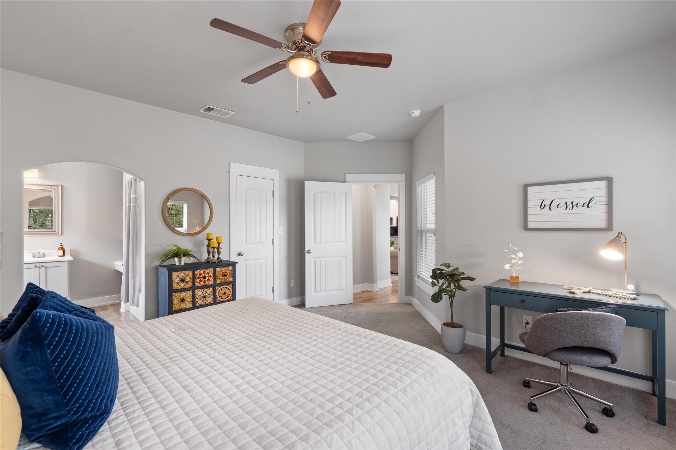 13105 Rooster Springs Road Austin, TX 78737 - Photo 14 of 38 This second primary bedroom features light gray walls, a ceiling fan with light, and carpeted flooring